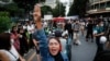 Pro-democracy demonstrators flash a three-finger salute of defiance during a protest rally in the Silom business district of Bangkok, Thailand, Oct. 29, 2020. 