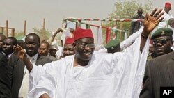 Nigerian President Goodluck Jonathan waves to the crowd on arrival at a campaign rally in Kano, northern Nigeria, March 16, 2011