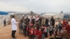 A doctor talks with refugees at a camp for displaced people in Atme, in Syria's northwestern Idlib province, near the border with Turkey, March 14, 2020. 