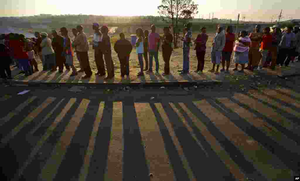 The country goes to the polls in the fifth democratically held election since the end of apartheid. Seen in this photo, South Africans queue to cast their votes at sunset near a polling station in the Alexandra township of Johannesburg, South Africa, May 7, 2014.
