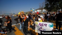 Migrants and human right activists protest against the U.S. and Mexico immigration policies and for the right to seek asylum, at the San Ysidro border crossing port in Tijuana.