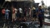 FILE - Security forces and civilians gather at the scene of a suicide car bomb attack in the capital's eastern Shiite-dominated New Baghdad neighborhood, Iraq, April 25, 2016.