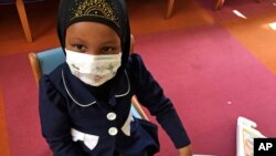 FILE - Amira Hassan, of Burnsville, Minnesota, plays in the waiting room at the specialty clinic at Children's Minnesota in Minneapolis, Minnesota, May 2, 2017.