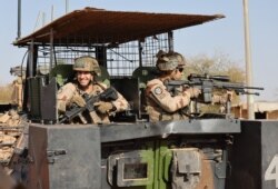 FILE - French soldiers of the Barkhane force patrol the streets of Timbuktu, northern Mali, Dec. 5, 2021. France's anti-jihadist military force in the Sahel region, which involves over 5,000 troops, will end in the first quarter of 2022.