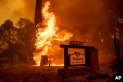 The Carr Fire tears through Shasta, Calif., July 26, 2018. Fueled by high temperatures, wind and low humidity, the blaze destroyed multiple homes and at least one historic building.