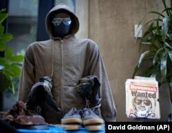 In this file photo from May 18, 2011, the hoodie and sunglasses used by Ted Kaczynski, also known as the Unabomber, are displayed as Kaczynski's personal items are auctioned off online with proceeds to benefit the victims' families in Atlanta.