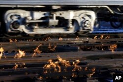 A Metra train moves southbound to downtown Chicago as the gas-fired switch heater on the rails keeps the ice and snow off the switches near Metra Western Avenue station in Chicago, Jan. 29, 2019.