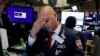 FILE - Specialist Mario Picone works on the floor of the New York Stock Exchange, Aug. 14, 2019. The Dow Jones industrial average sank 800 points that day after the bond market flashed a warning sign about a possible recession.