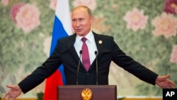 Russian President Vladimir Putin speaks during a news conference after the Shanghai Cooperation Organization (SCO) Summit in Qingdao in eastern China's Shandong Province, June 10, 2018.