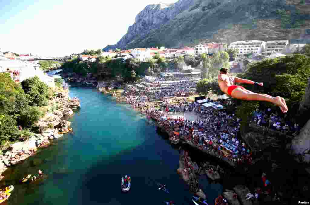 A man jumps from the Old Bridge during 450th traditional diving competition in Mostar, Bosnia and Herzegovina.