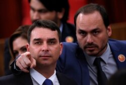 FILE - Flavio Bolsonaro, left, and Carlos Bolsonaro, sons of Brazil's President-elect Jair Bolsonaro (not pictured), are seen in Brasilia, Brazil, Dec. 10, 2018.