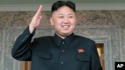 North Korean leader Kim Jong Un watches a military parade held to celebrate the centenary of the birth of the North's founder Kim Il Sung, in Pyongyang on April 15, 