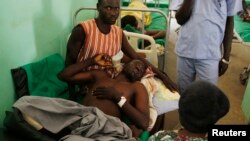FILE - A Sudan People's Liberation Movement soldier, wounded in a Sudanese air force bombing in South Kordofan, lies in a hospital in Gidel, April 30, 2012.
