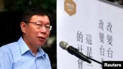 Taipei mayoral candidate Ko Wen-je gives a speech ahead of the local election in a park in Taipei, November 27, 2014.