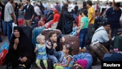 Palestinians wait to cross into Egypt at Rafah crossing between Egypt and southern Gaza Strip, Aug. 24, 2013. 