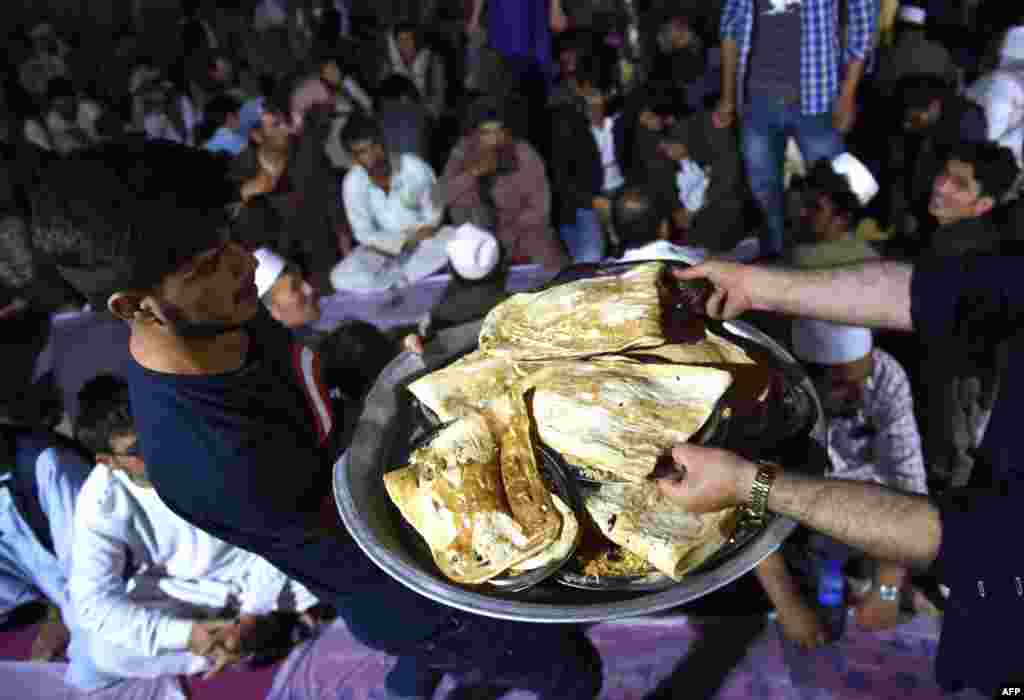 Afghan Muslims distribute food as others break their fast during the Islamic holy month of Ramadan at the Wazir Akbar Khan Mosque in Kabul.