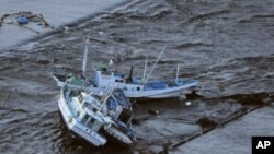 Fishing boats are swept by a tsunami in Oarai City in Ibaragi Prefecture, northeastern Japan March 11, 2011