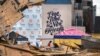 FILE - Workers clean up the site of the Historic Karnofsky Shop, that collapsed during Hurricane Ida in New Orleans, Louisiana, Sept. 6, 2021.