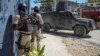 Police stand guard in front of the Police Academy during a funeral of three police officers killed in the line of duty in Port-au-Prince, Haiti, Jan. 31, 2023. On April 9, 2023 three more officers were killed in an ambush.