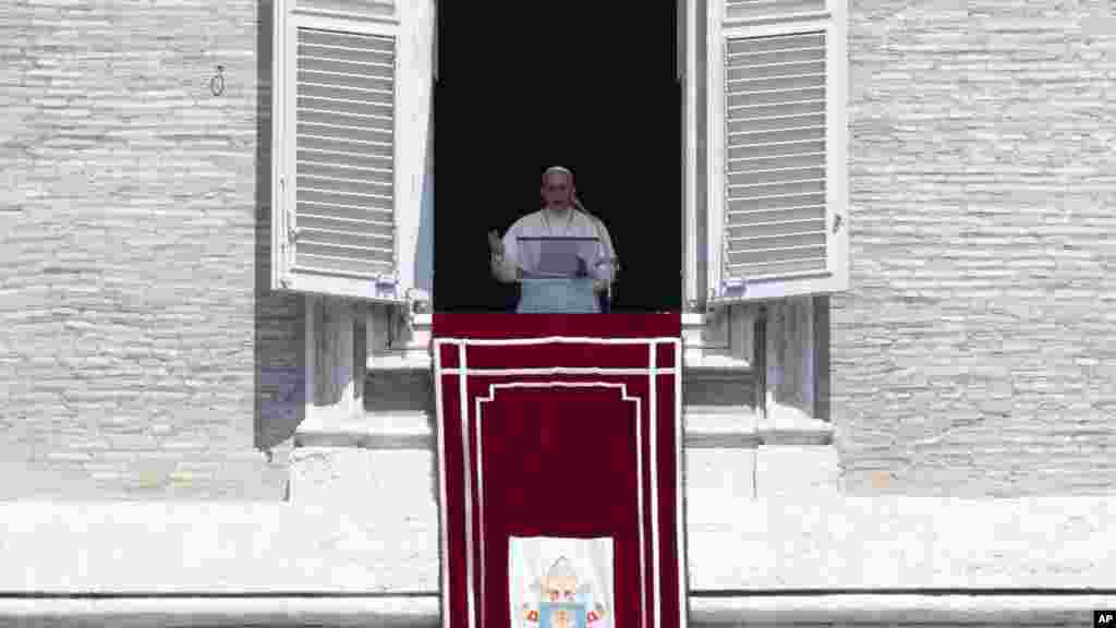 Pope Francis urged the international community to find a solution to the problems in Iraq on Sunday. Here, he delivers his blessing during the Angelus noon prayer he celebrated from the window of his studio overlooking St. Peter's Square, at the Vatican, Aug. 10, 2014. 