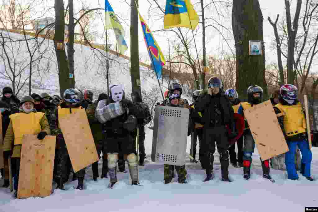 Members of various anti-government paramilitary groups attend a religious service at a chapel in Kyiv, Jan. 29, 2014. 