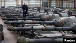 FILE — Freddy Versluys, the CEO of Belgian defense company OIP Land Systems, stands among dozens of German-made Leopard 1 tanks in a hangar in Tournais, Belgium, Jan. 31, 2023. He told Reuters he has sold 50 tanks to another European government.