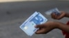 FILE - A person holds a 1000 naira note in Abuja, Nigeria, Dec. 15, 2022.