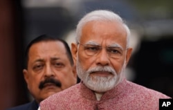 FILE - Indian Prime Minister Narendra Modi, center, addresses the media on the opening day of the winter session of the Parliament, in New Delhi, India, Dec. 7, 2022.