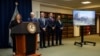 A screen shows a photo of Lafarge's cement plant in Jalabiyeh, Syria, as the deputy Attorney General of the United States Lisa Monaco, left, speaks during a press conference at the U.S. Attorney's Office in New York, Oct. 18, 2022.