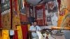 FILE - A Tibetan artisan makes traditional wall decorations inside his workshop at Majnu Ka Tila, a Tibetan refugee camp in New Delhi, India, April 27, 2016. 