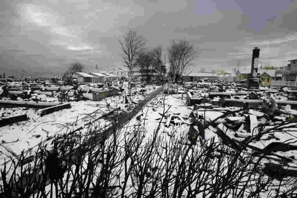 The fire-scorched landscape of Breezy Point in New York, which was devastated during Superstorm Sandy when a fire pushed by the raging winds destroyed many homes, is seen after a Nor&#39;easter snow, November 8, 2012.