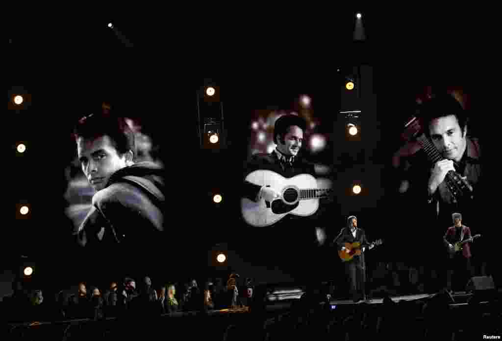 Vince Gill (L) and Ben Haggard perform "Mama Tried" as images of a young Merle Haggard are shown at the 50th Annual Country Music Association Awards in Nashville, Tennessee, Nov. 2, 2016. The country music icon died on his 79th birthday, April 6, 2016, after a long battle with his health.