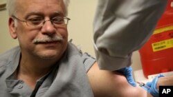 Steve Sierzega receives a measles, mumps and rubella vaccine at the Rockland County Health Department in Pomona, N.Y., March 27, 2019. 