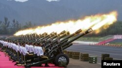 Polisi paramiliter dan anggota regu tembakan kehormatan menembakkan meriam dalam latihan parade militer menandai 70 tahun diakhirinya Perang Dunia II di Beijing, China, 1 Agustus 2015 (Foto: dok). 
