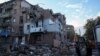 FILE - Rescuers work at the site of a residential building hit by a Russian missile strike, amid Russia's attack on Ukraine, in Kharkiv, May 31, 2024.