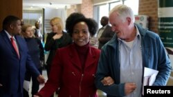 Malcolm McGowan, father of South African Stephen McGowan, who was kidnapped by al-Qaida from Timbuktu in 2011 and has been released and is back home, chats to Foreign Minister Nkoana-Mashabane after a media briefing in Pretoria, August 3, 2017. 