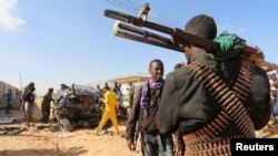 Somali security forces at the scene of a car bombing in Somalia's capital Mogadishu, February 27, 2017. Officials say another bomb killed one person in the capital, Mogadishu, early Tuesday.
