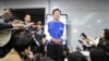 South Korea's main opposition Democratic Party leader Lee Jae-myung, center, speaks to reporters after watching TV broadcasting results of exit polls for the parliamentary election at the National Assembly on April 10, 2024, in Seoul, South Korea. 