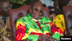 Zimbabwean President Robert Mugabe smiles during a youth rally in Marondera about 100 kilometers east of Harare, June, 2, 2017. 