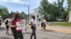 Julia Young, marching with her father Malcolm, in an Arlington, Virginia, “Say Their Names” protest against police brutality. (VOA/Carolyn Presutti)