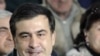 Georgian President Mikheil Saakashvili speaks with people in the village of Rachisubani, some 50 km outside Tbilisi, 14 Mar 2009. Outraged Georgians on March 14 slammed a local television channel that sparked panic by broadcasting on March 13 a fake repor