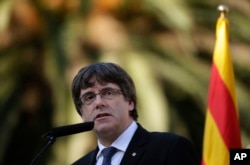 FILE - Catalan regional President Carles Puigdemont addresses the media in Barcelona, Spain, Oct. 15, 2017.
