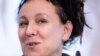 Polish author Olga Tokarczuk, recipient of the 2018 Nobel Prize in Literature, smiles during a press conference in Bielefeld, Germany, Thursday, Oct 10, 2019 