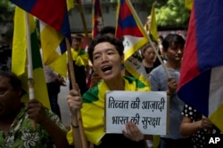 Exile Tibetans shout slogans during a protest to show support with India on Doklam standoff in New Delhi, India, Aug. 11, 2017.