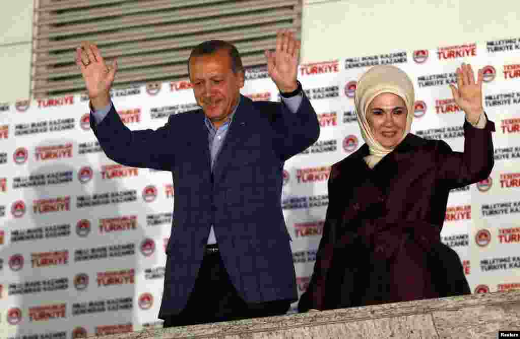 Turkey's Prime Minister Tayyip Erdogan and wife Ermine wave to supporters as they celebrate his presidential victory, in front of the party headquarters, in Ankara, Aug. 10, 2014.