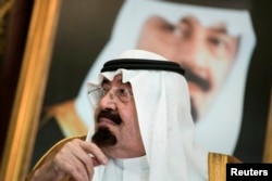 FILE - Saudi King Abdullah bin Abdul Aziz al-Saud sits before a meeting with U.S. Secretary of State John Kerry at the Royal Palace, Jeddah, Sept. 11, 2014.
