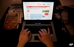 FILE - An Indian man is seen surfing the internet in New Delhi.