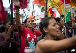 Government supporters march during an anti-imperialist rally in Caracas, Venezuela, Saturday, March 30, 2019.