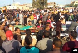 Injured people are evacuated from the scene of a militant attack on a mosque in Bir al-Abd in the northern Sinai Peninsula of Egypt, Nov. 24, 2017.