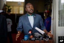FILE - President Pierre Nkurunziza makes a brief statement at the presidential palace in Bujumbura, Burundi.